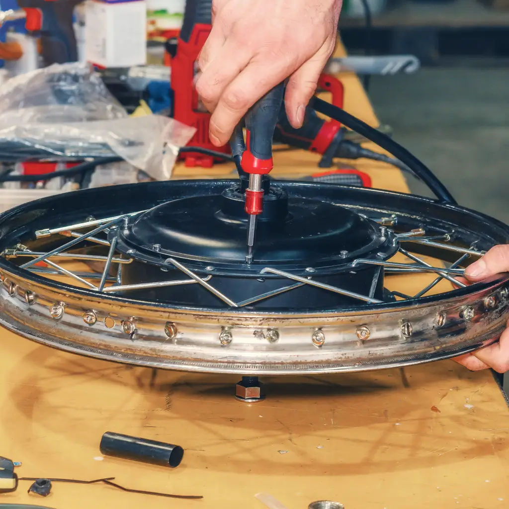 Mechanic inspecting an electric bicycle battery mount and charging port